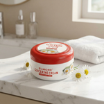 Jar of Elmore Glycerine Cream on a marble surface with flowers and bottles in the background