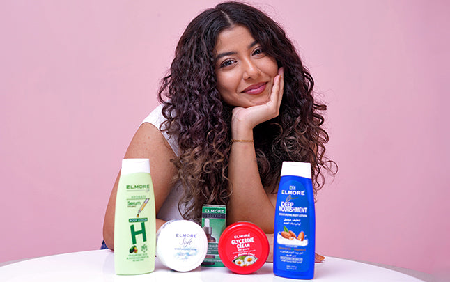 Model with Elmore skincare range including body lotion, serum and facewash products
